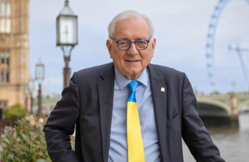 Sir Peter standing in front of Parliament