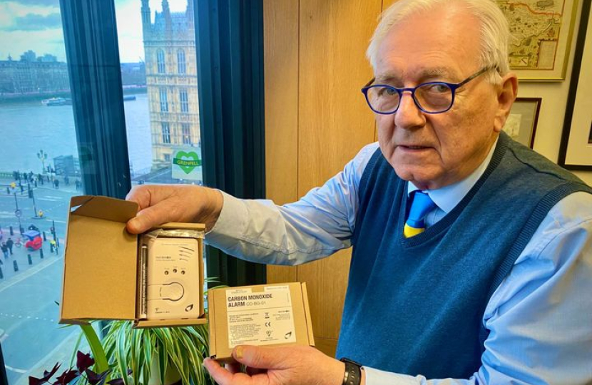 Sir Peter holding a Carbon Monoxide Alarm