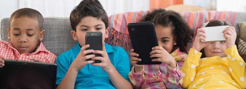 A group of children using smartphones and other devices