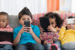 A group of children using smartphones and other devices