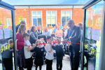 Sir Peter cutting the ceremonial ribbon at Palatine Primary School