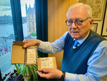 Sir Peter holding a Carbon Monoxide Alarm