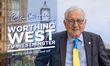 Sir Peter standing in front of Parliament