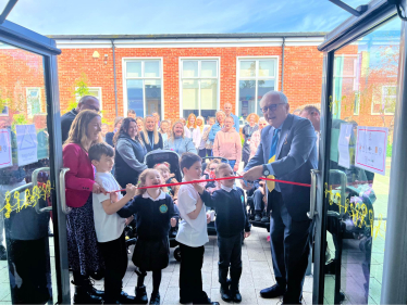 Sir Peter cutting the ceremonial ribbon at Palatine Primary School